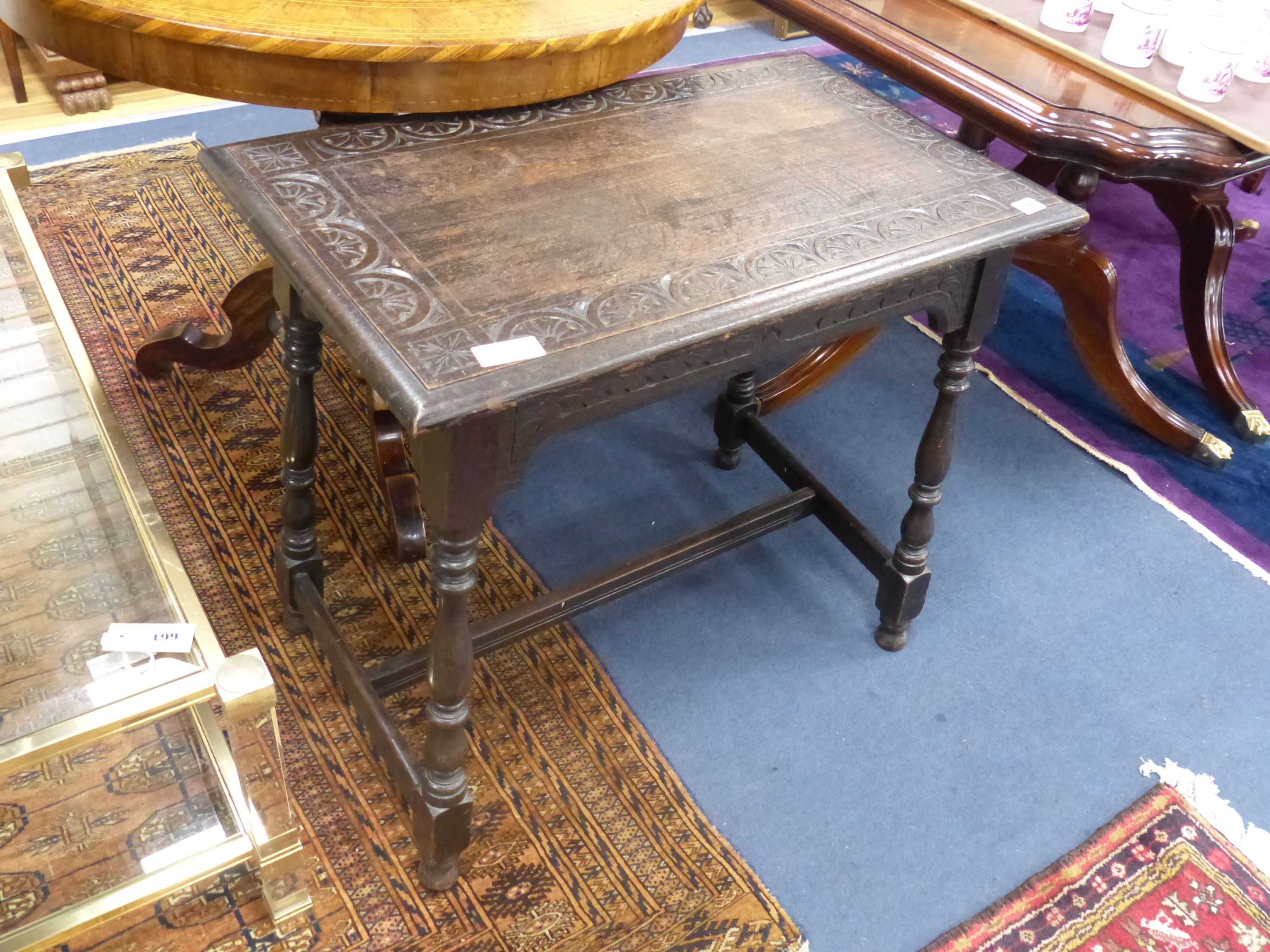 An early 20th century rectangular carved oak occasional table, width 75cm, depth 45cm, height 67cm